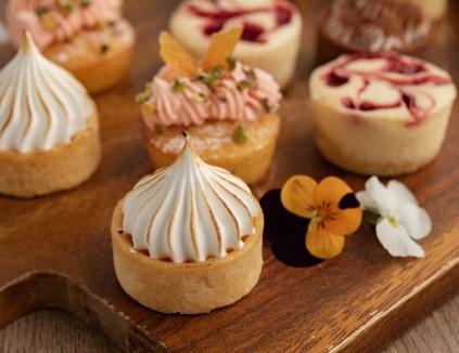Mini pavlovas and desserts on a catering platter