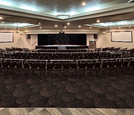 Large function room set theatre-style with a stage
