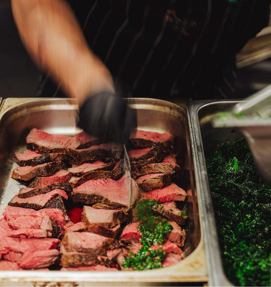 Chef carving roast beef at a carvery station